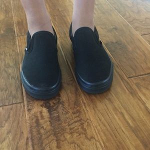 All black slip on vans